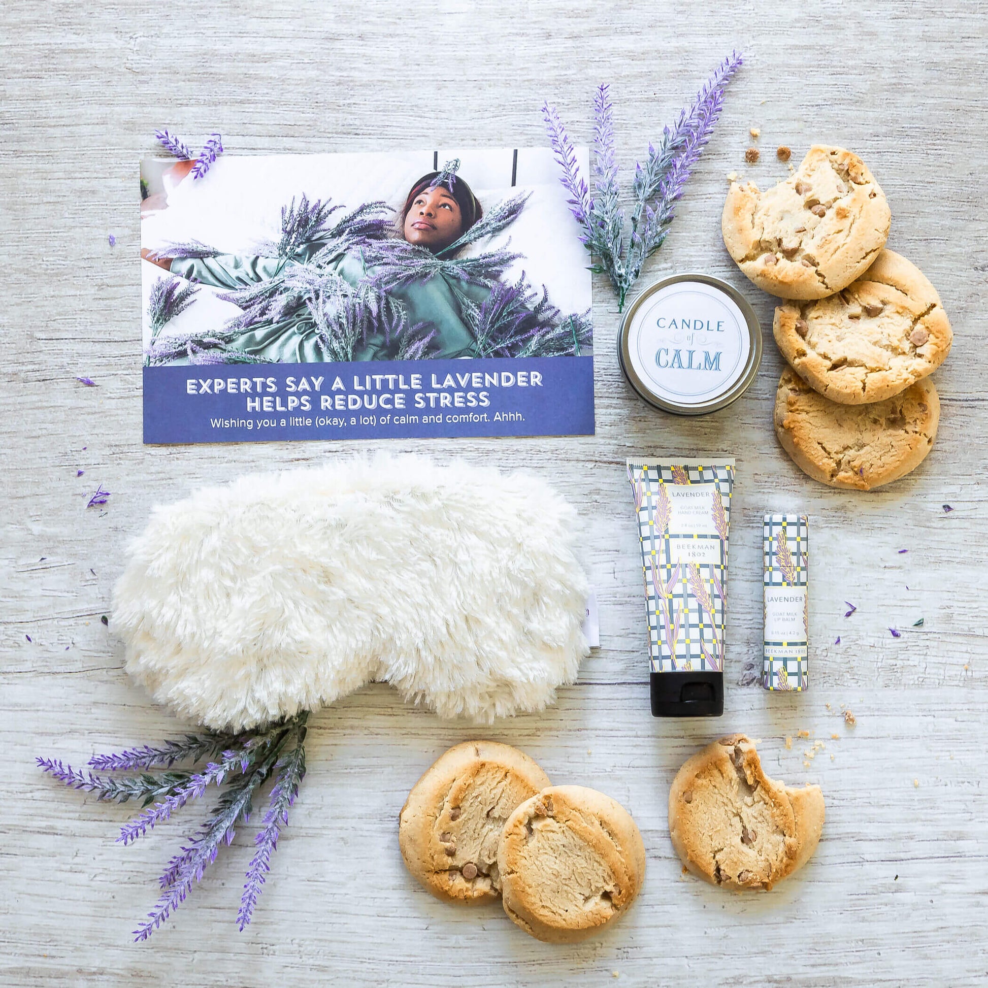 meme lavender package: Rolls, relax candle, lavender hand lotion and lip balm, fuzzy eye mask surrounding insert card that reads: Experts say a little lavender helps reduce stress. Also have decorative lavender probs