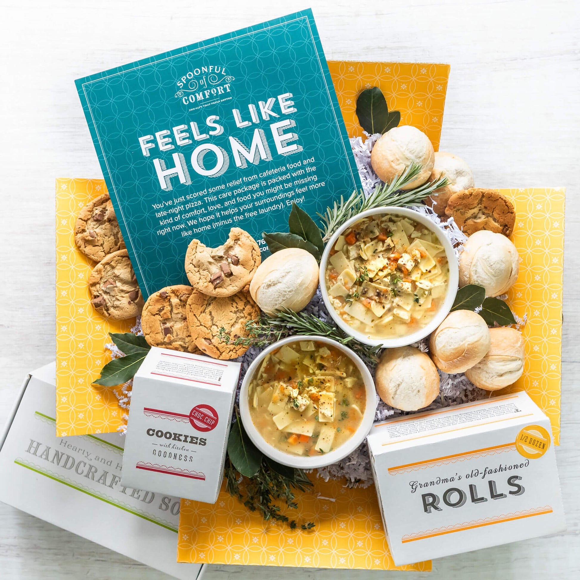 College Care Package shows two bowls of chicken noodle soup surrounded by cookies and rolls. Includes insert that reads: Feels Like Home