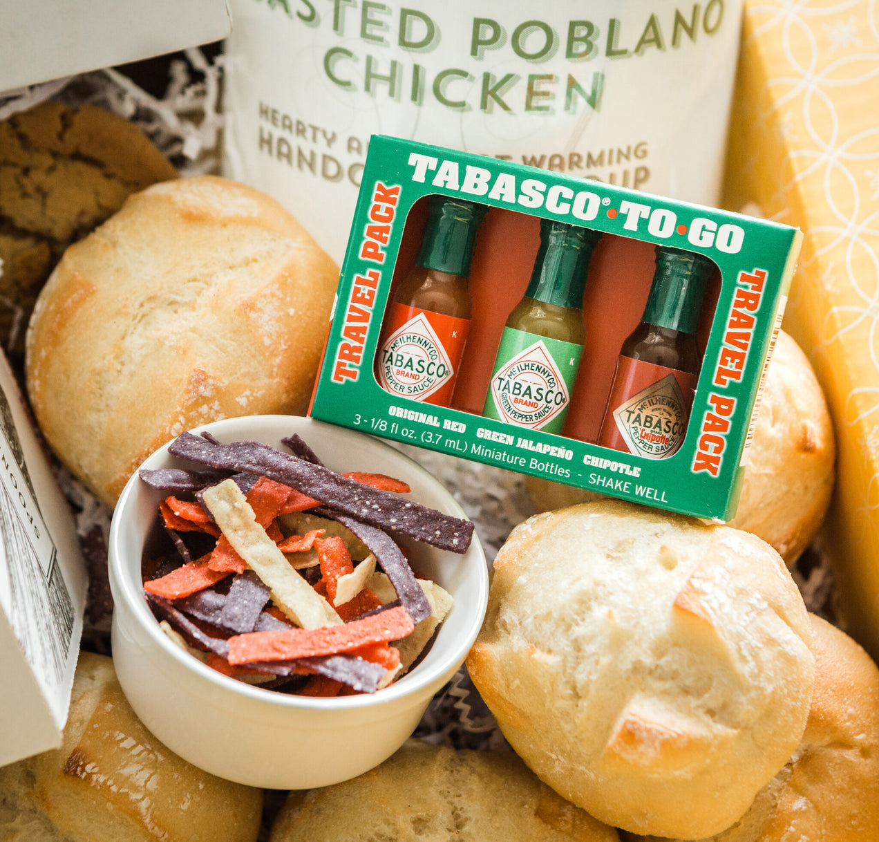 Tabasco To Go, travel pack. Original Red, Green Jalapeno, chipotle. 3 - 1/8 oz 3.7 ml Miniature Bottles - Shake Well. Surrounded by decorative props
