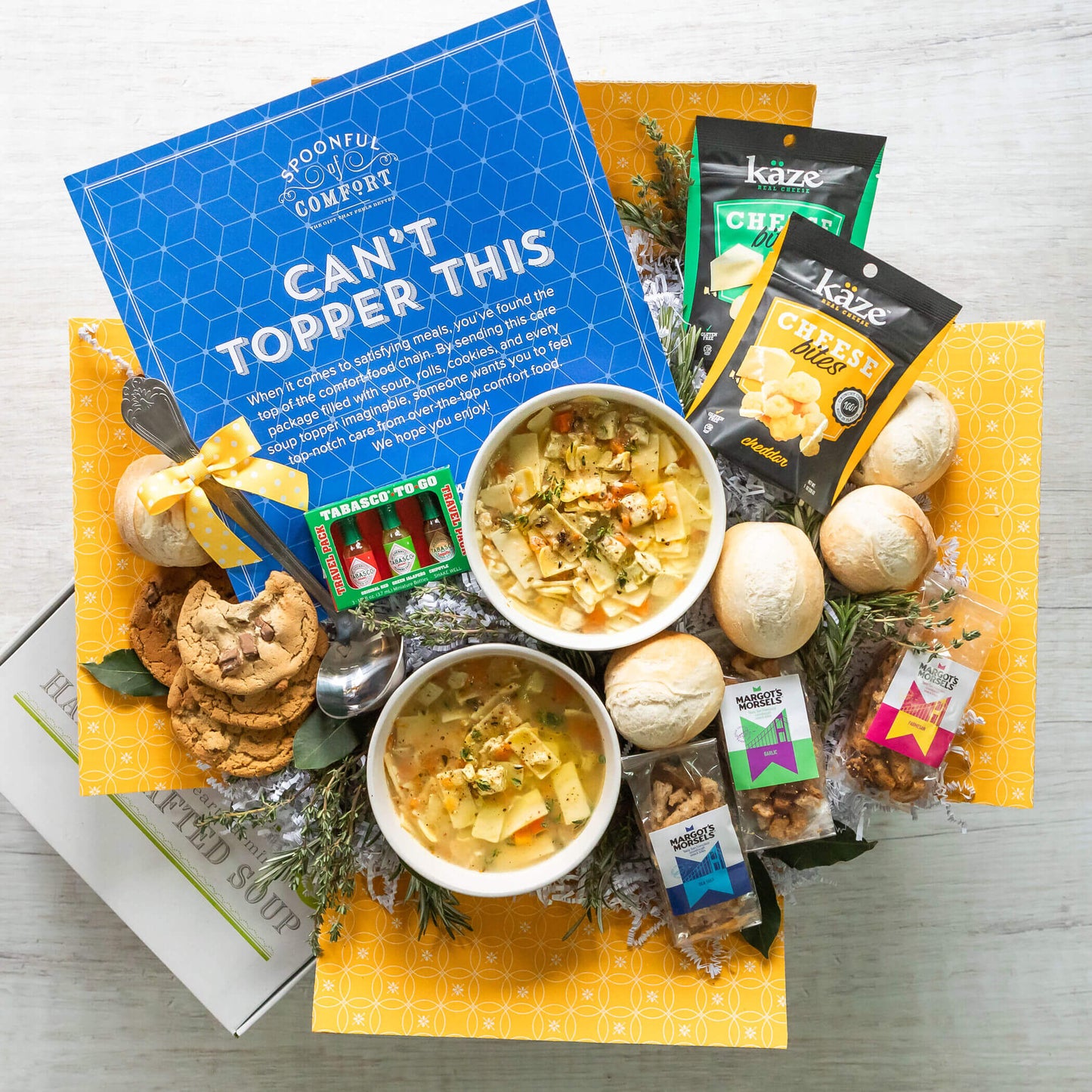 Can't Top this Package: Includes two bowls of soup surrounded by, cookies, rolls, croutons (garlic, parmesan, sea salt flavors), along with Kaze Cheese bites(gouda and cheddar), tabasco trio set. Also includes ladle and insert. Insert reads: Can't Topper This