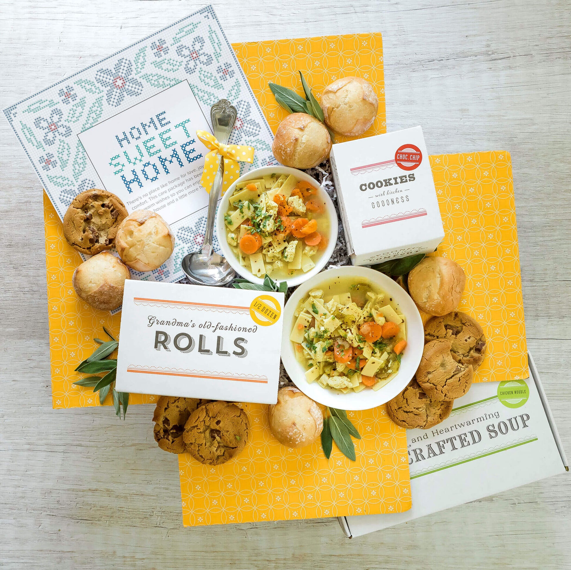 Housewarming Package: Two bowls of chicken noodle soup surrounded by rolls and cookies. Ladle and insert in image Insert reads: Home Sweet Home